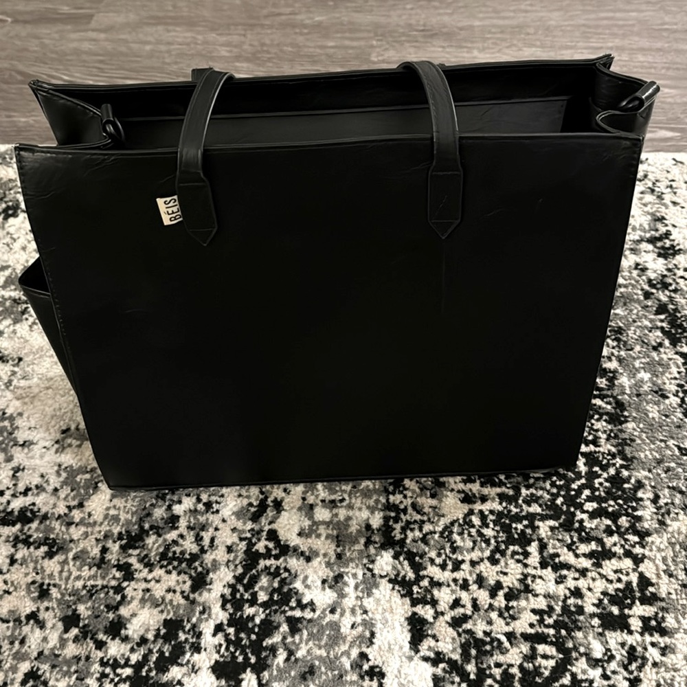 Black Beis bag. Multiple zips and pockets with a water bottle holder on the side